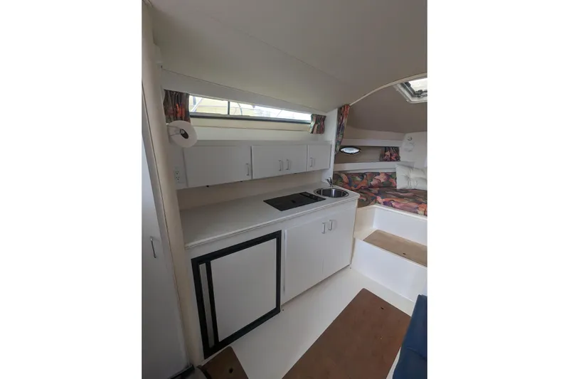 Slide: The Image of Interior of 1995 Wellcraft 330 Coastal boat with kitchenette and seating area. - 8
