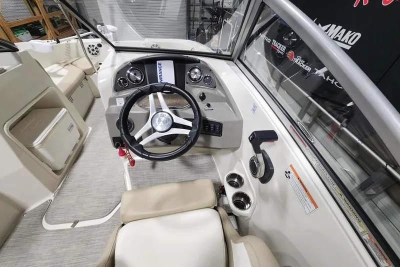 Slide: The Image of 2017 Stingray 201 DC boat interior with steering wheel and control panel. - 5