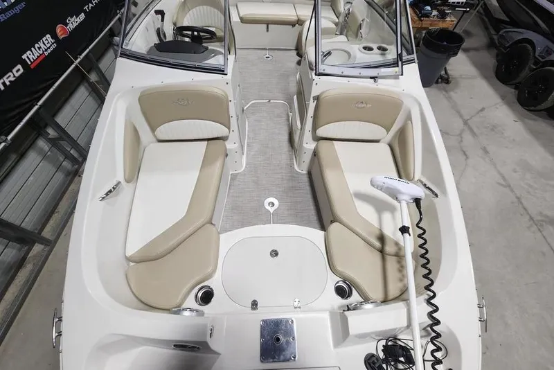 Slide: The Image of 2017 Stingray 201 DC boat interior with beige seating and modern design. - 7