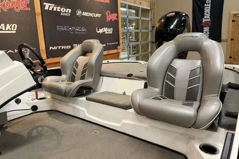 Slide: The Image of 2026 Nitro Z18 boat interior with gray seats and steering wheel. - 5