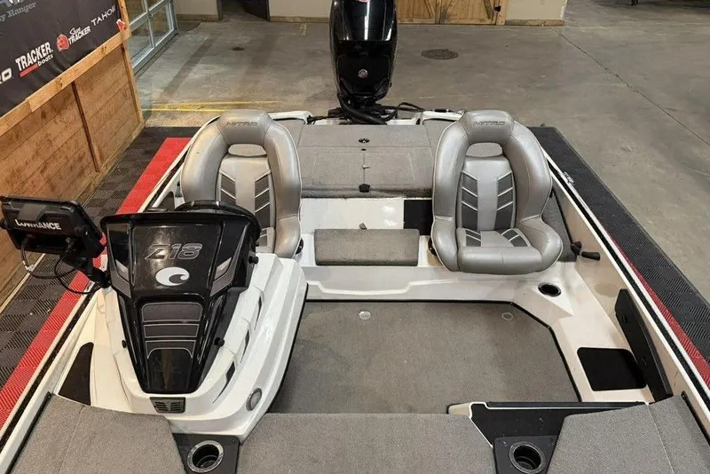 Slide: The Image of 2026 Nitro Z18 boat interior with dual seats and control panel in a showroom. - 6