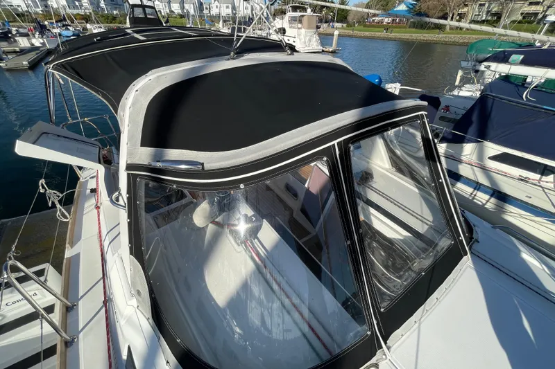 Slide: The Image of 2015 Beneteau First 235 sailboat with black canopy docked at marina. - 10