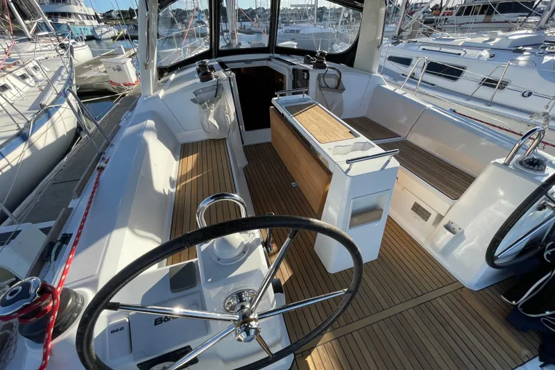 Slide: The Image of Cockpit of 2015 Beneteau First 235 sailboat with teak flooring and dual steering wheels. - 13