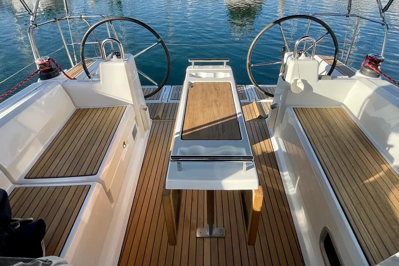 Slide: The Image of Cockpit of 2015 Beneteau First 235 sailboat with dual steering wheels and wooden seating. - 14