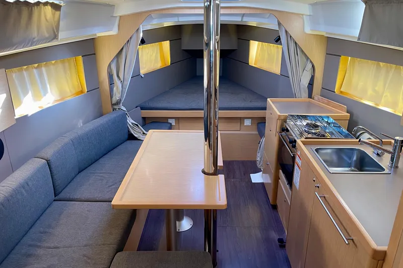 Slide: The Image of Interior of 2015 Beneteau Oceanis 35 sailboat with cozy seating, kitchenette, and sleeping area. - 16