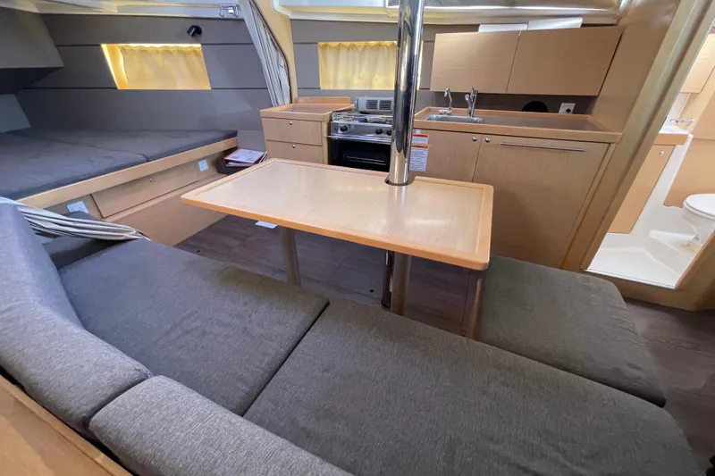 Slide: The Image of Interior of 2015 Beneteau First 235 sailboat with cozy seating and compact kitchen area. - 17