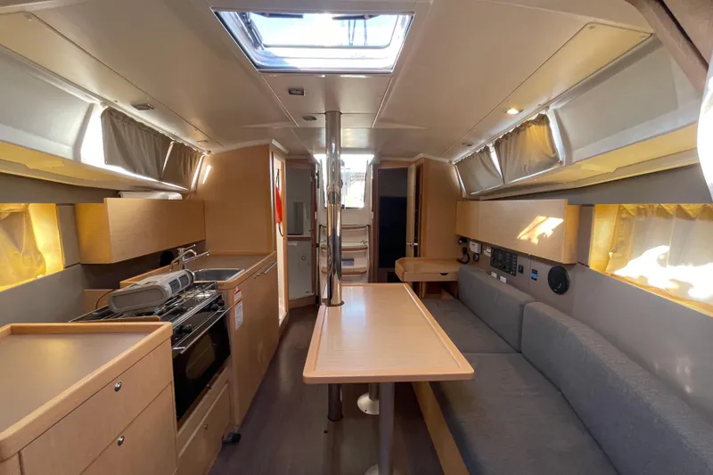 Slide: The Image of Interior of 2015 Beneteau First 235 sailboat, featuring modern kitchen and seating area. - 19