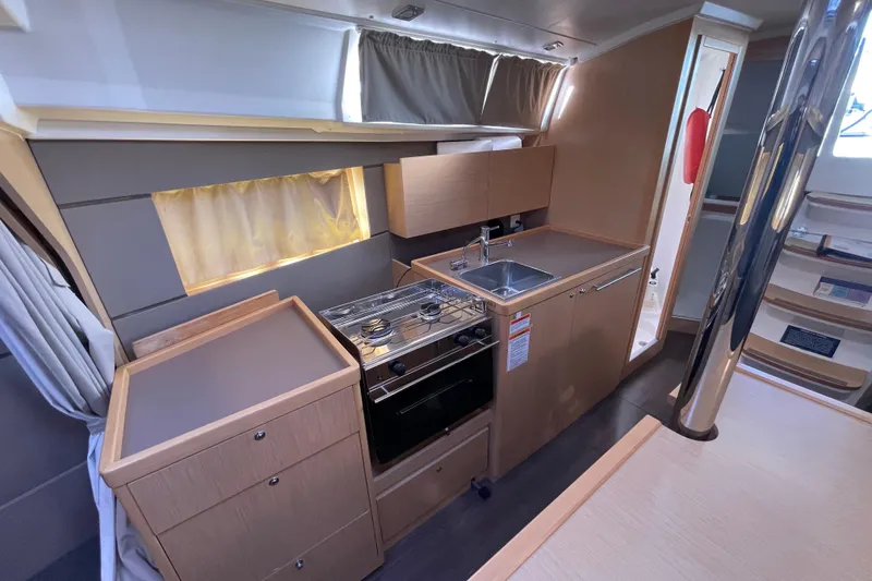 Slide: The Image of Modern galley kitchen in 2015 Beneteau First 235 sailboat, featuring stove and sink. - 20