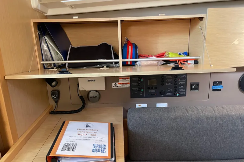 Slide: The Image of Interior of a 2015 Beneteau First 235 sailboat with navigation equipment and storage. - 23