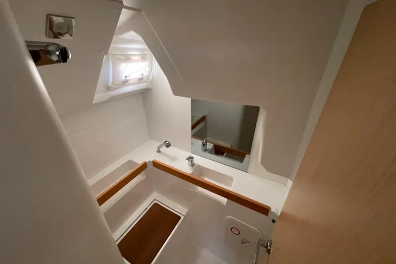 Slide: The Image of Compact bathroom interior of 2015 Beneteau First 235 sailboat, featuring sink and mirror. - 26