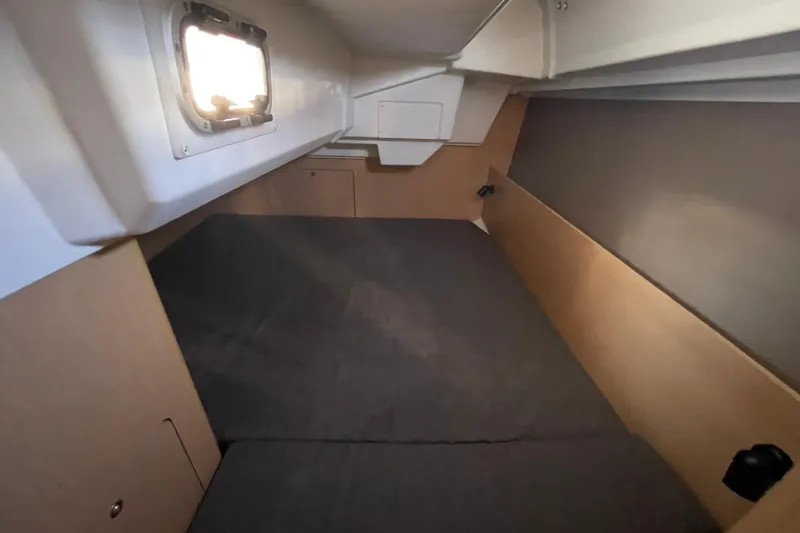 Slide: The Image of Interior cabin of 2015 Beneteau First 235 sailboat, featuring a cozy sleeping area. - 28
