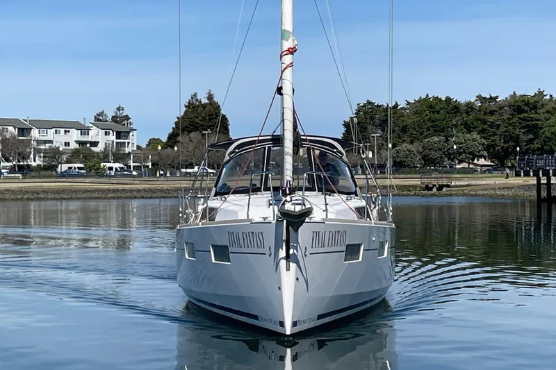 Slide: The Image of Sailboat "Final Fantasy," Beneteau First 235, 2015 model, on calm water near shoreline. - 3