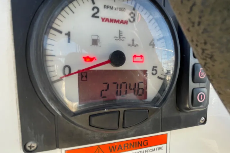 Slide: The Image of Yanmar engine gauge on 2015 Beneteau First 235, displaying 2704.6 hours. - 32