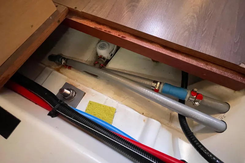 Slide: The Image of Bilge area of 2015 Beneteau First 235 sailboat showing plumbing and wiring. - 33