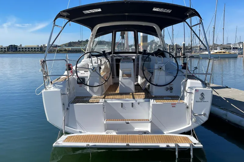Slide: The Image of 2015 Beneteau First 235 sailboat docked, featuring dual steering wheels and a sleek design. - 37