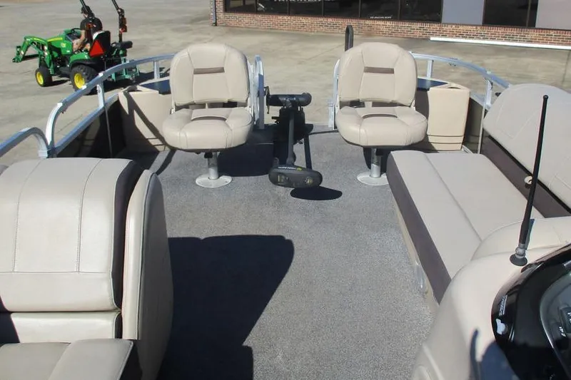 Slide: The Image of 2026 Sun Tracker Fishin' Barge 24 DLX interior with seating and fishing equipment. - 10
