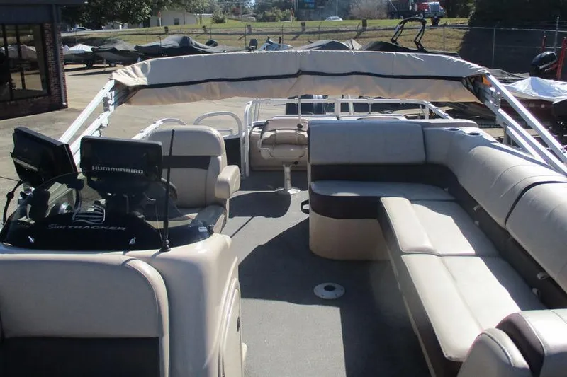 Slide: The Image of 2026 Sun Tracker Fishin' Barge 24 DLX interior with seating and canopy. - 12