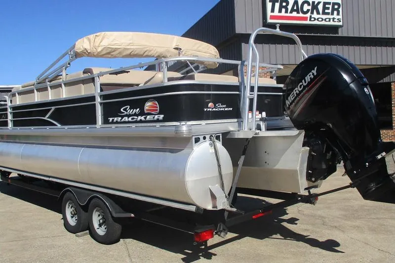 Slide: The Image of 2026 Sun Tracker Fishin' Barge 24 DLX pontoon boat with Mercury outboard motor. - 3