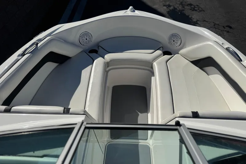 Slide: The Image of 2015 Yamaha Boats AR190 interior with white seating and built-in speakers. - 11