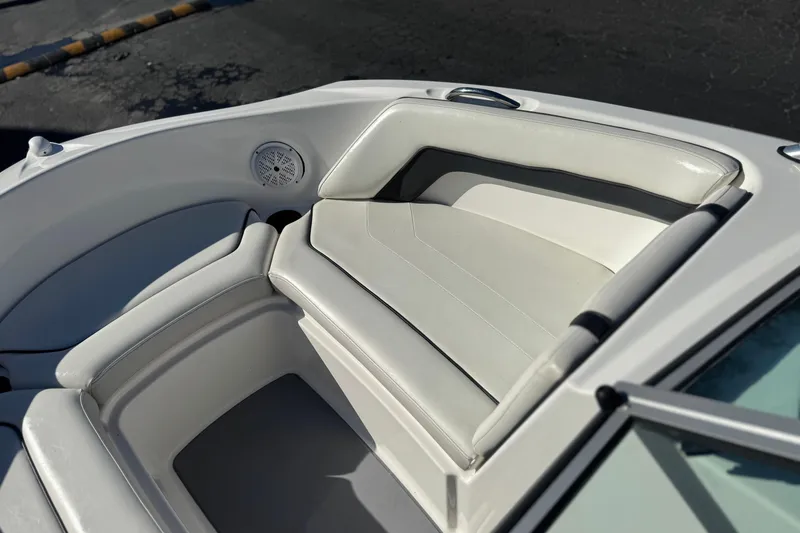 Slide: The Image of 2015 Yamaha Boats AR190 interior seating with white upholstery and speaker detail. - 13