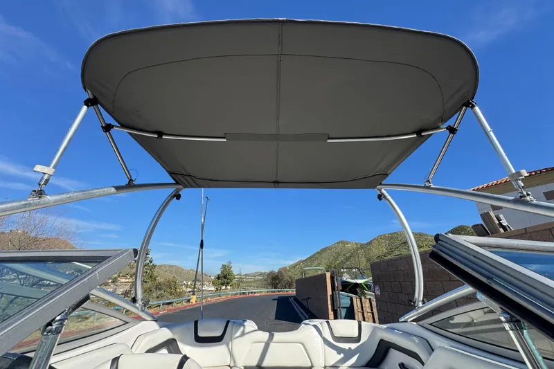 Slide: The Image of 2015 Yamaha AR190 boat with bimini top, scenic mountain backdrop. - 15