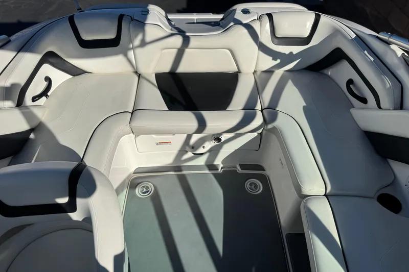 Slide: The Image of Interior seating of a 2015 Yamaha Boats AR190, featuring white and black upholstery. - 16