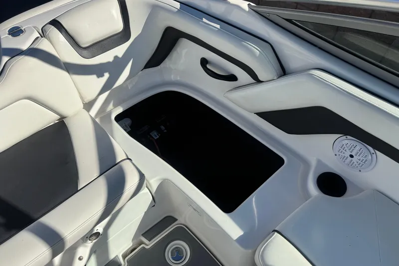 Slide: The Image of 2015 Yamaha AR190 boat interior with white and black seating and storage compartment. - 19