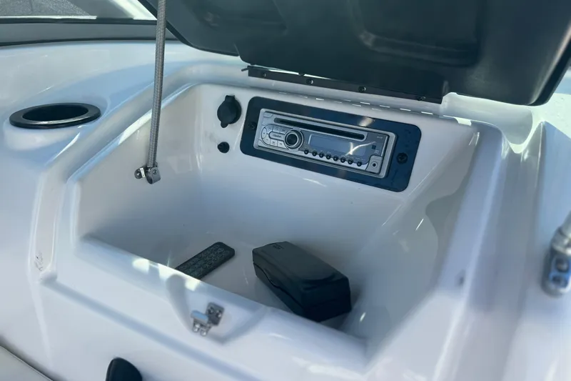 Slide: The Image of 2015 Yamaha AR190 boat dashboard with stereo system and storage compartment. - 21