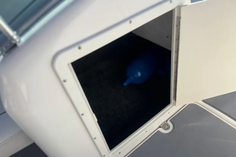 Slide: The Image of Open storage compartment on a 2015 Yamaha AR190 boat, revealing interior space. - 23