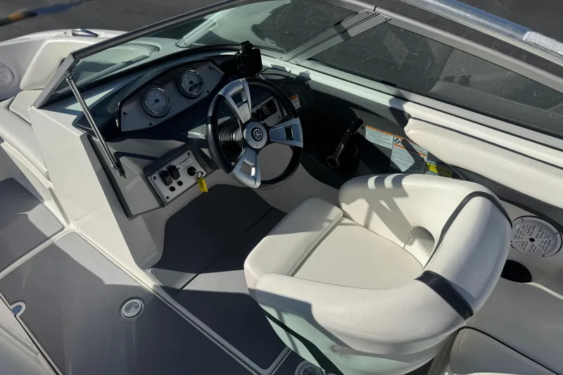 Slide: The Image of 2015 Yamaha Boats AR190 cockpit with steering wheel and white captain's chair. - 24