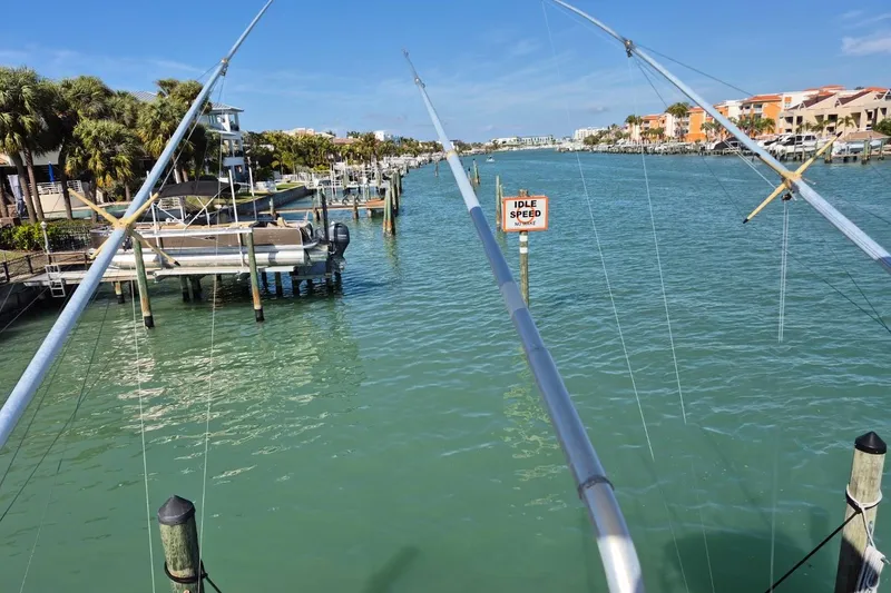 Slide: The Image of 2004 Riviera 4000 Offshore view, calm marina waters, idle speed sign, sunny day. - 16