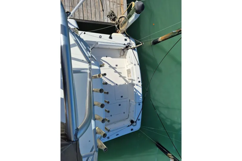 Slide: The Image of 2004 Riviera 4000 Offshore boat docked, viewed from above, showing deck and mooring lines. - 17