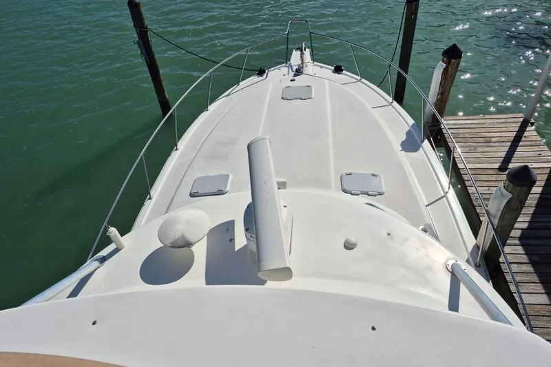 Slide: The Image of 2004 Riviera 4000 Offshore boat docked, aerial view of deck and surrounding water. - 18