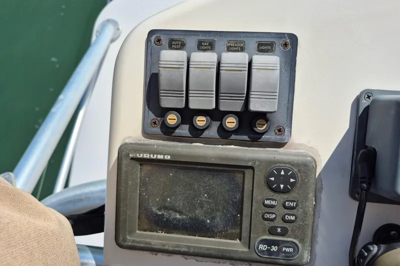 Slide: The Image of Control panel of a 2004 Riviera 4000 Offshore boat with navigation switches. - 20