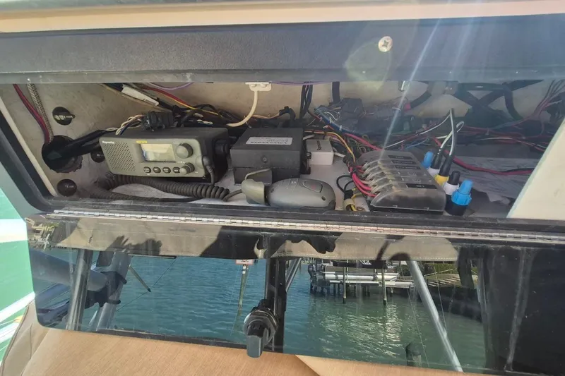 Slide: The Image of Electrical panel of a 2004 Riviera 4000 Offshore boat with radio and wiring. - 22