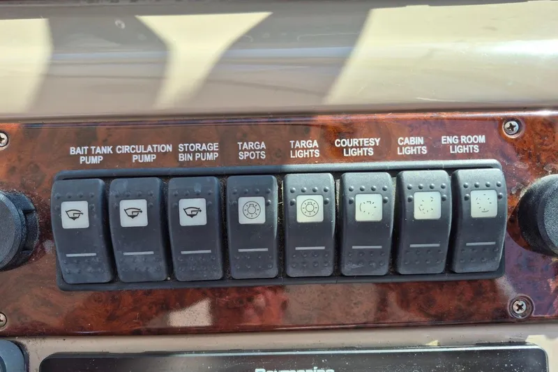 Slide: The Image of Control panel of a 2004 Riviera 4000 Offshore boat with labeled switches. - 29