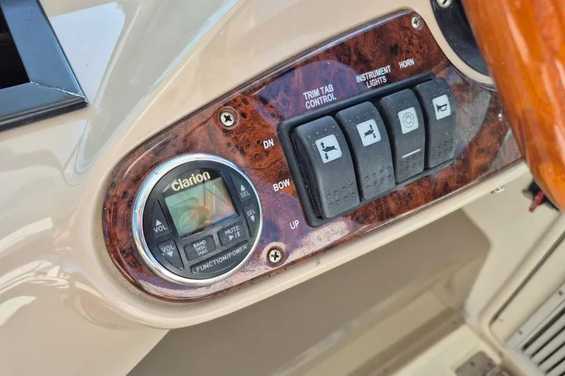 Slide: The Image of 2004 Riviera 4000 Offshore control panel with Clarion audio system and switches. - 31