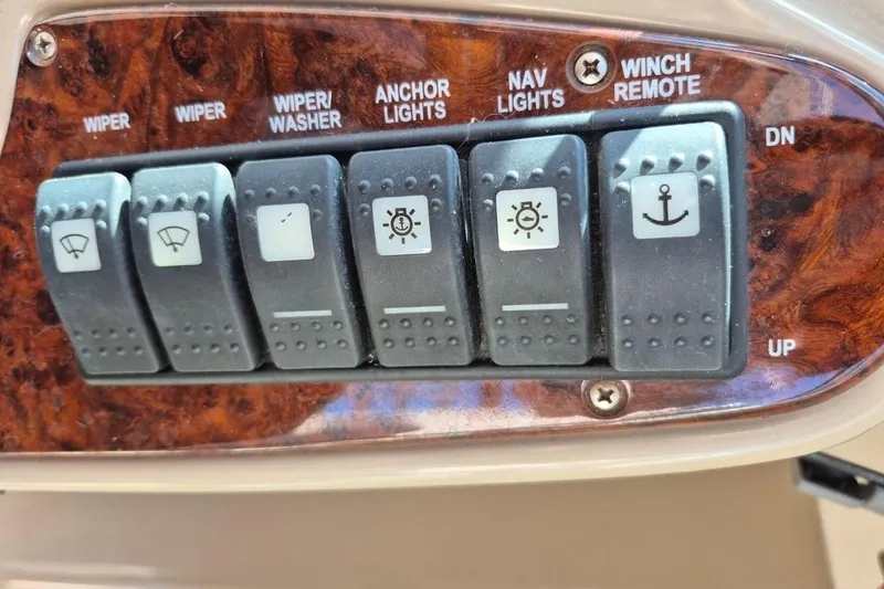 Slide: The Image of Control panel of a 2004 Riviera 4000 Offshore boat with various switches. - 32