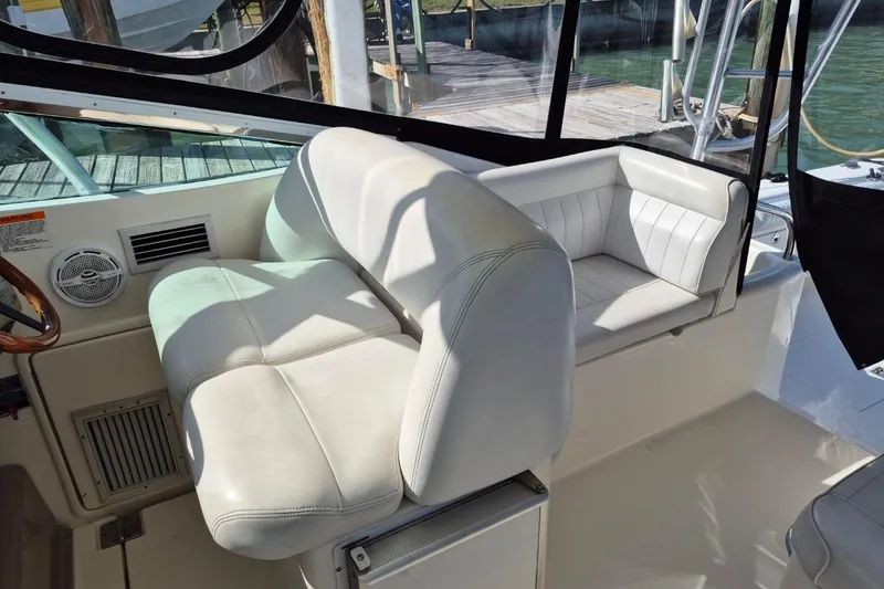 Slide: The Image of 2004 Riviera 4000 Offshore boat interior with white leather seating and wooden accents. - 33