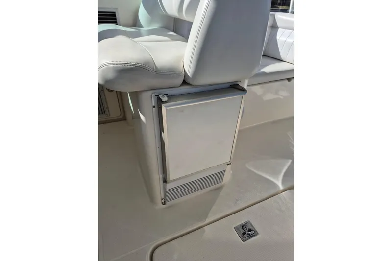 Slide: The Image of 2004 Riviera 4000 Offshore boat interior with white seating and storage compartment. - 34