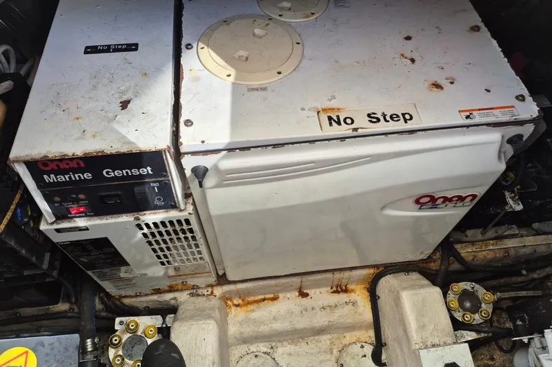 Slide: The Image of Onan marine generator in a 2004 Riviera 4000 Offshore engine room, labeled "No Step." - 38