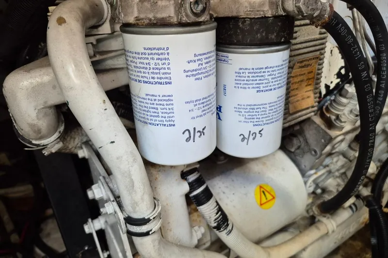 Slide: The Image of Engine components of a 2004 Riviera 4000 Offshore, featuring dual filters and labeled pipes. - 41