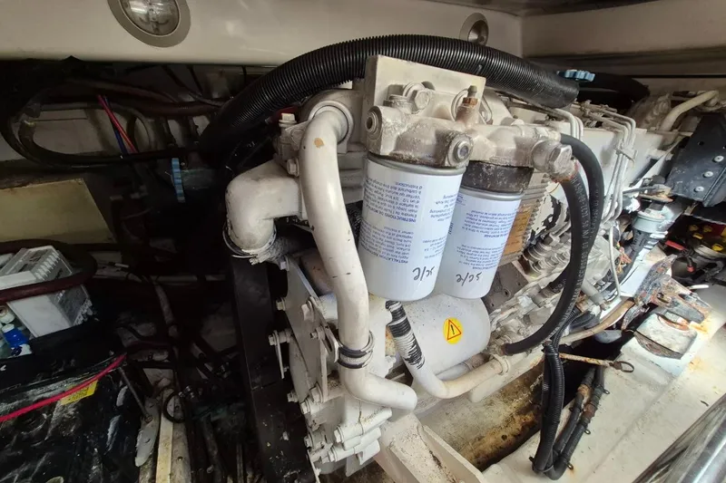 Slide: The Image of Engine compartment of a 2004 Riviera 4000 Offshore boat, showcasing filters and wiring. - 43