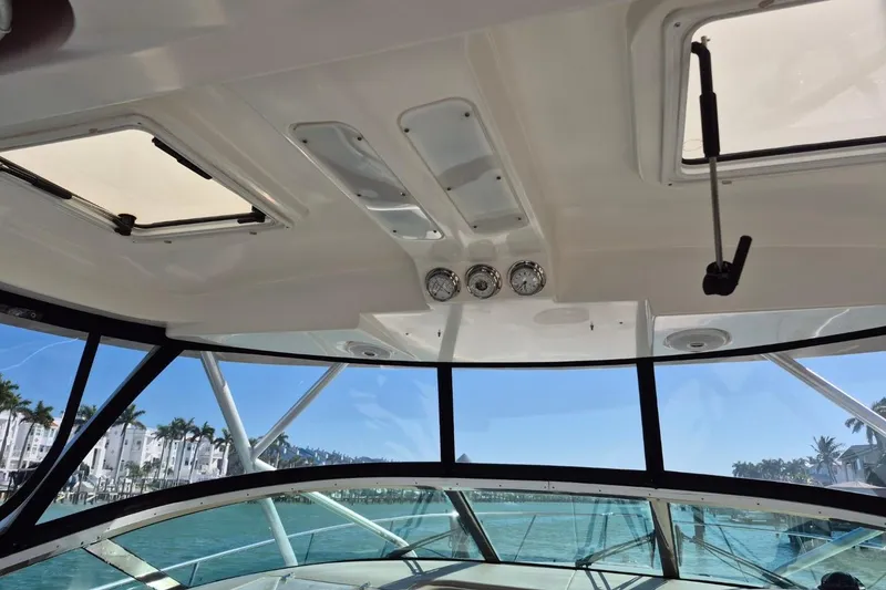 Slide: The Image of Interior view of 2004 Riviera 4000 Offshore boat with clear windows and gauges. - 49