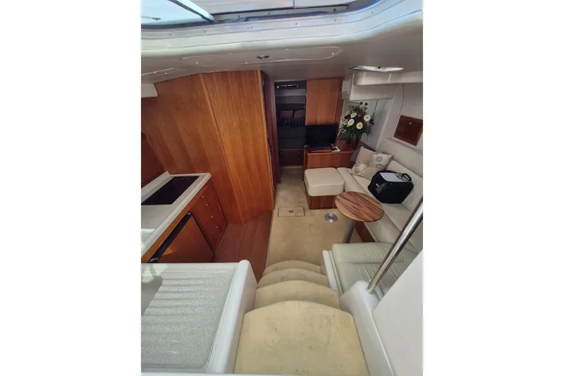 Slide: The Image of Interior of 2004 Riviera 4000 Offshore yacht with cozy seating and modern amenities. - 51