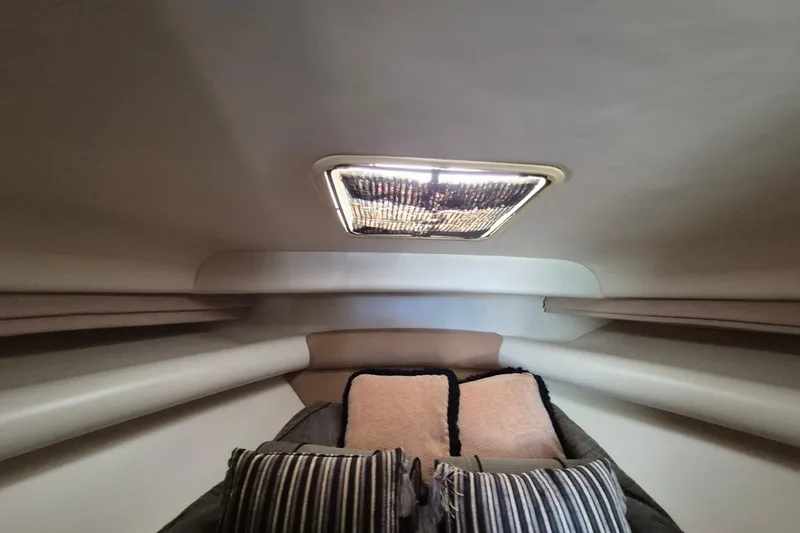 Slide: The Image of Interior cabin of 2004 Riviera 4000 Offshore yacht with cushions and overhead light. - 54