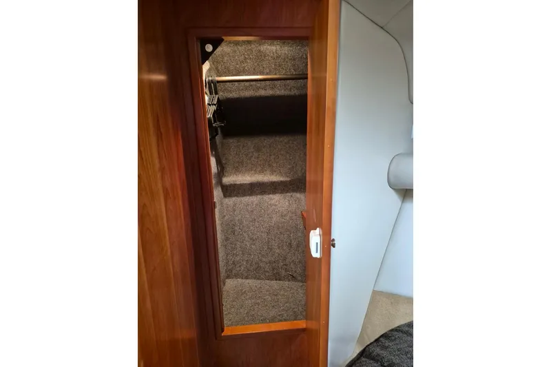 Slide: The Image of Interior view of 2004 Riviera 4000 Offshore boat closet with wooden door. - 55