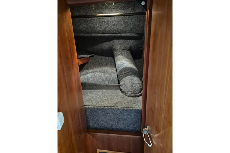 Slide: The Image of Interior cabin of 2004 Riviera 4000 Offshore yacht with wooden finish and cozy bedding. - 56