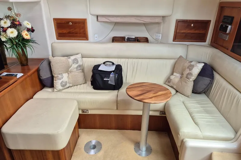 Slide: The Image of Luxurious interior of 2004 Riviera 4000 Offshore yacht with plush seating and wooden accents. - 62