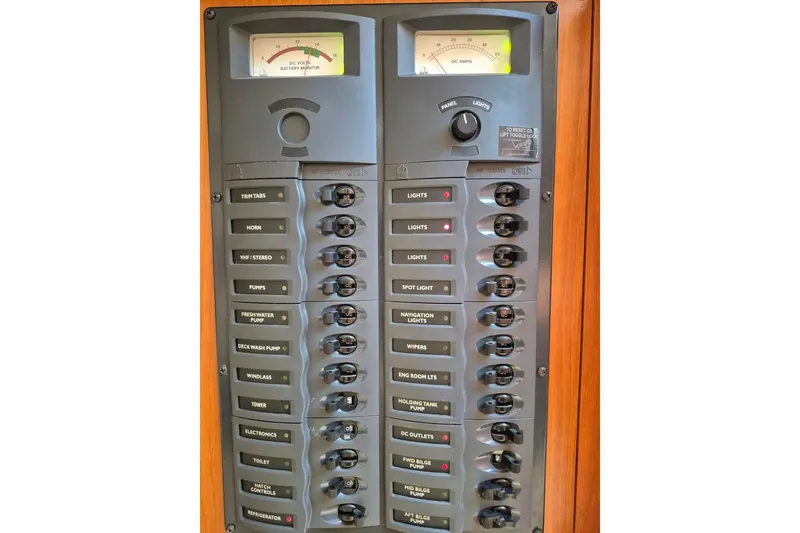 Slide: The Image of Electrical control panel on a 2004 Riviera 4000 Offshore boat, featuring various switches and gauges. - 65